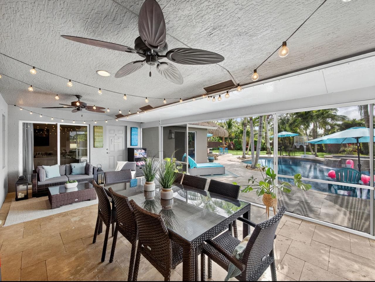 Covered patio with dining table and pool view